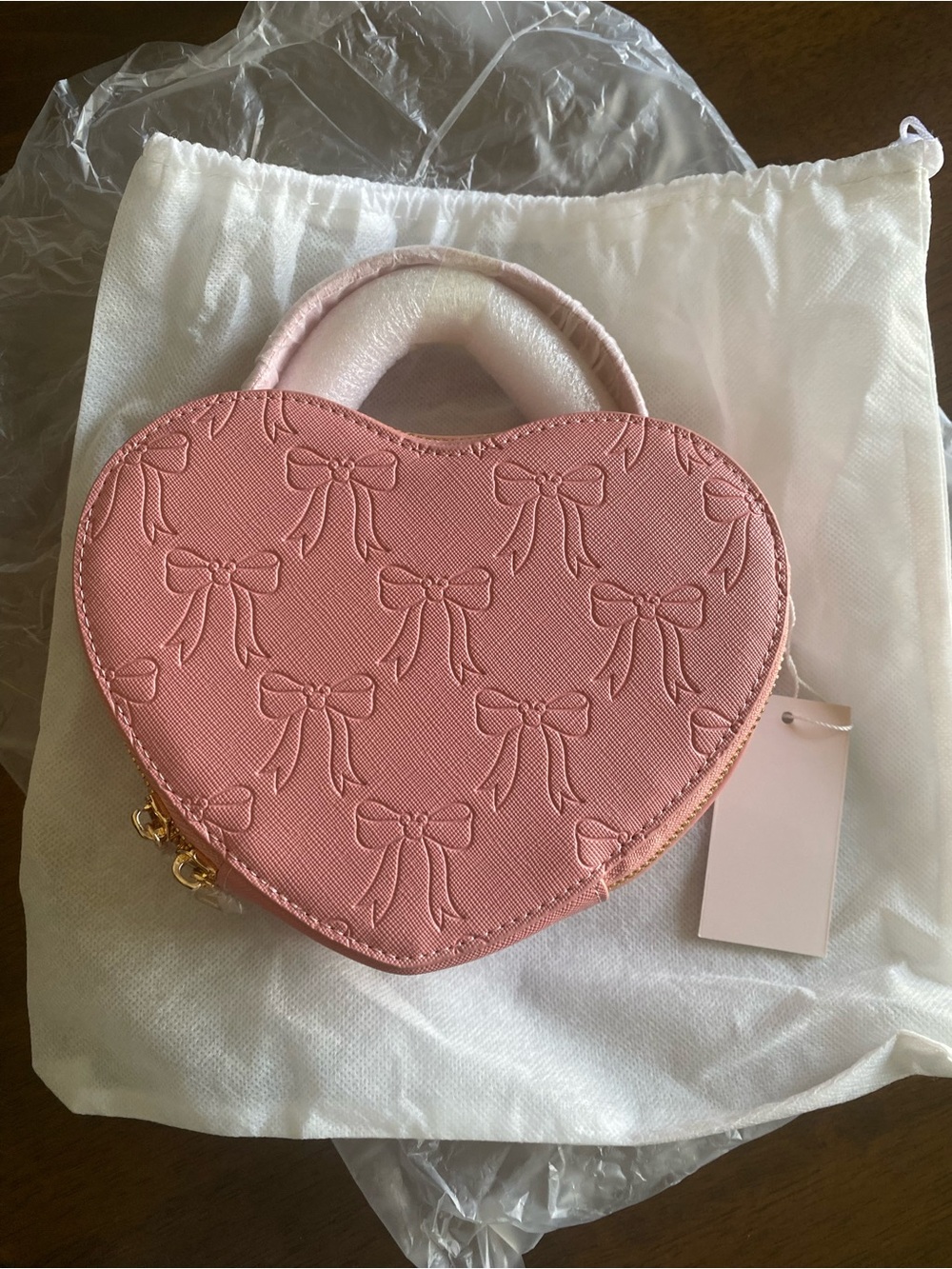 Heart-Shaped Pink Bow-Embossed Top-Handle Bag with crossbody strap